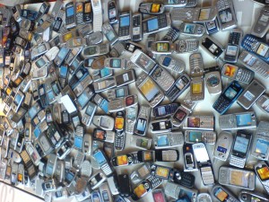 This image of a table full of outdated cell phones is brought to you by Octa, creators of the Whale Kit iPad stand.