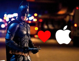 A man dressed as Batman stands on the street holding an iPad. The Whale Kit iPad grip is a great solution for grasping your tablet.